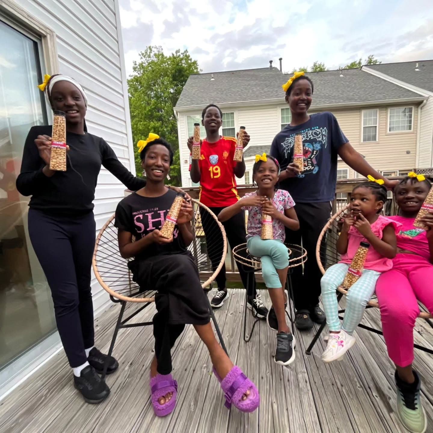 The EEMART family holding packages of roasted peanuts