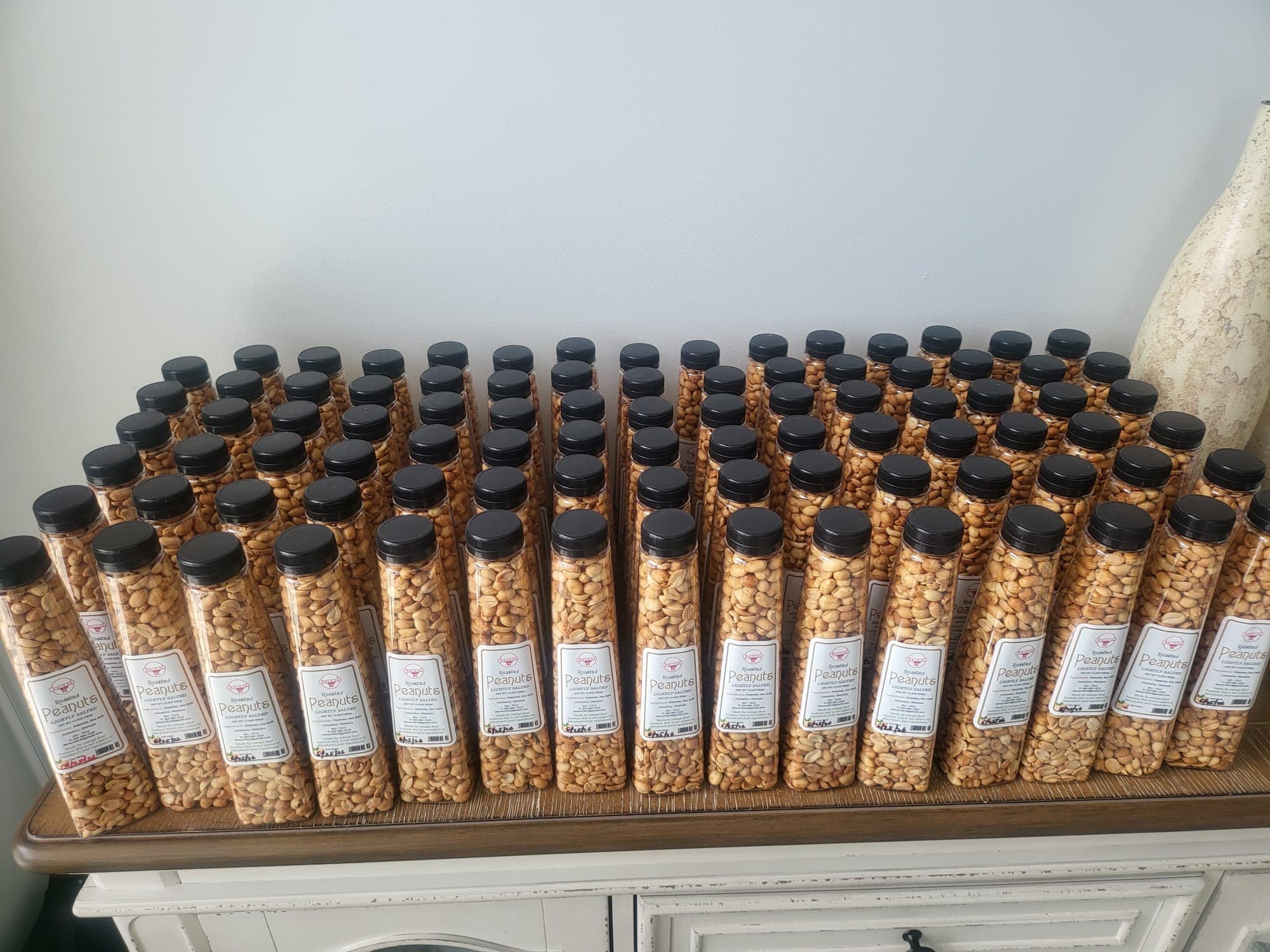 Rows of filled and labeled EEMART peanut bottles